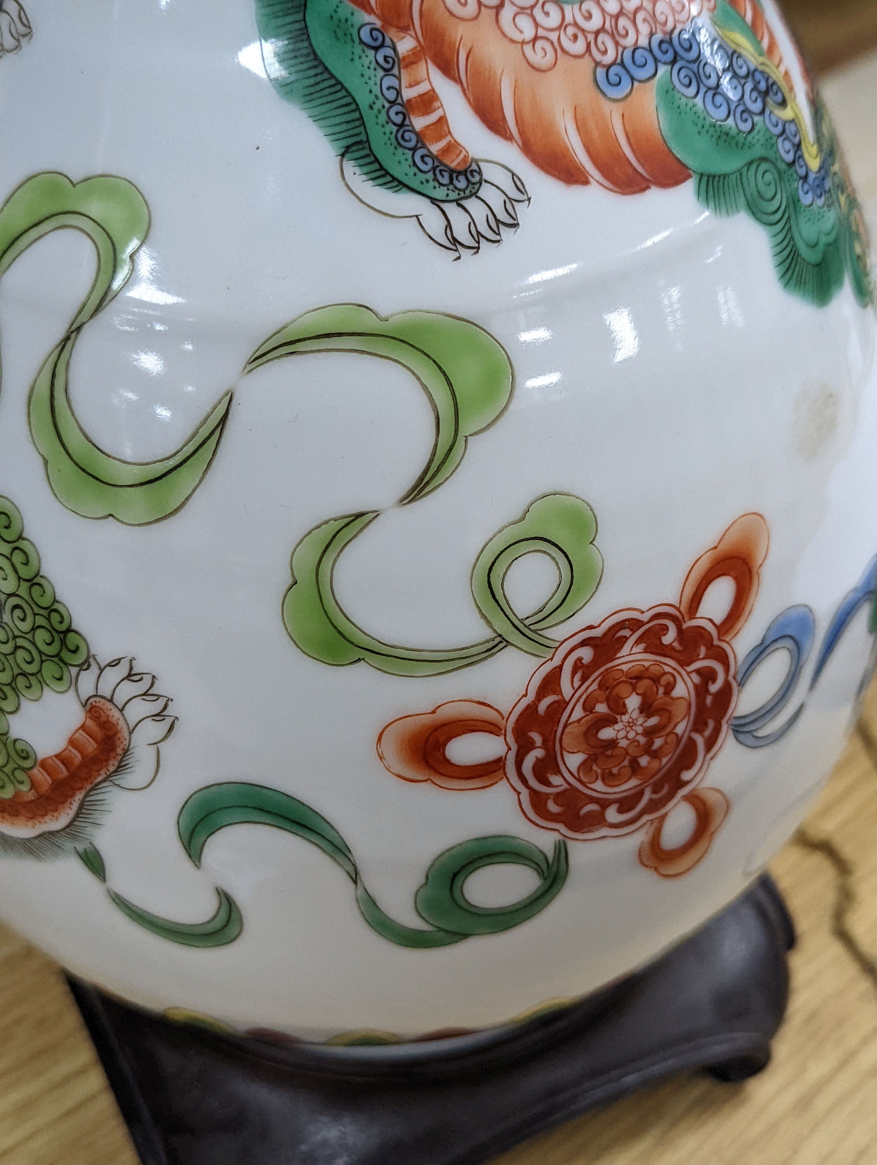 A Chinese famille verte pear-shaped ‘Buddhist lion’ vase, on stand, 32 cms high not including stand